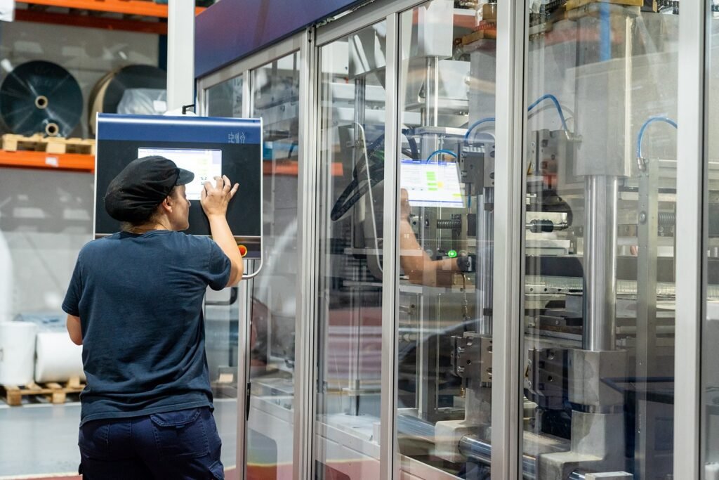 Imagen de nuestra encargada de montaje de maquinaria configurando los parámetros de una de nuestras líneas de producción